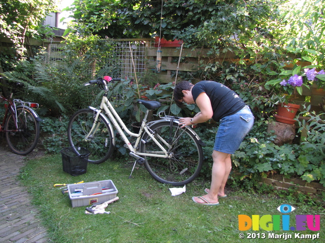 SX29554 Jenni installing lights on push bike